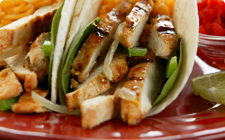 Chicken tacos with grilled vegetables and lime.